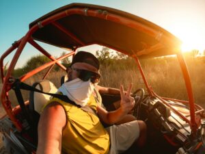 Men tourist having fun doing selfie during summer buggy tour